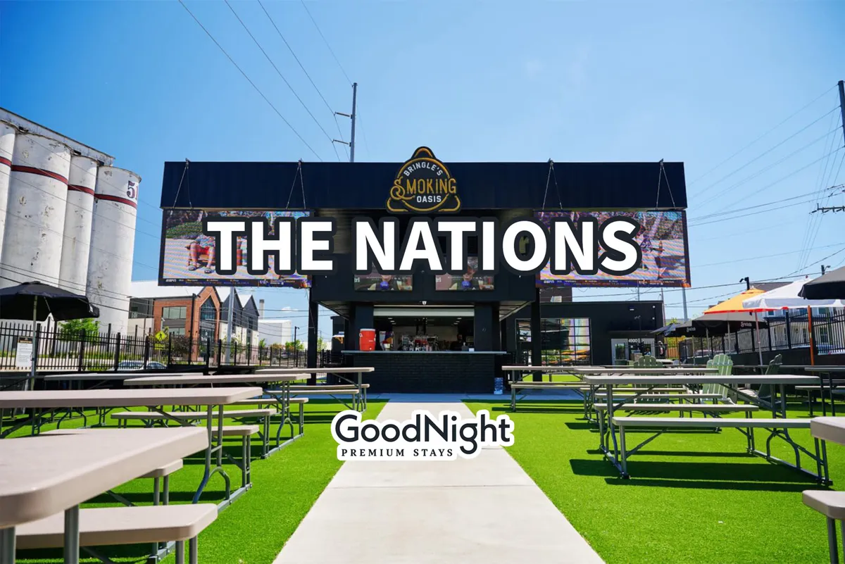 An energetic exterior shot showing The Nations sign, the Smoky Oasis building, and a bustling outdoor seating area. People are socializing, dining, and enjoying live events, capturing the vibrancy and community-oriented spirit of Nashville’s food and music scene.